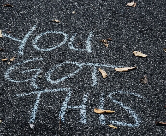 A dark Asphalt path with a slogan written in white chalk saying 'You Got This' to enforce the message that  Future You Success has articles to give the reader belief in what they want to achieve.