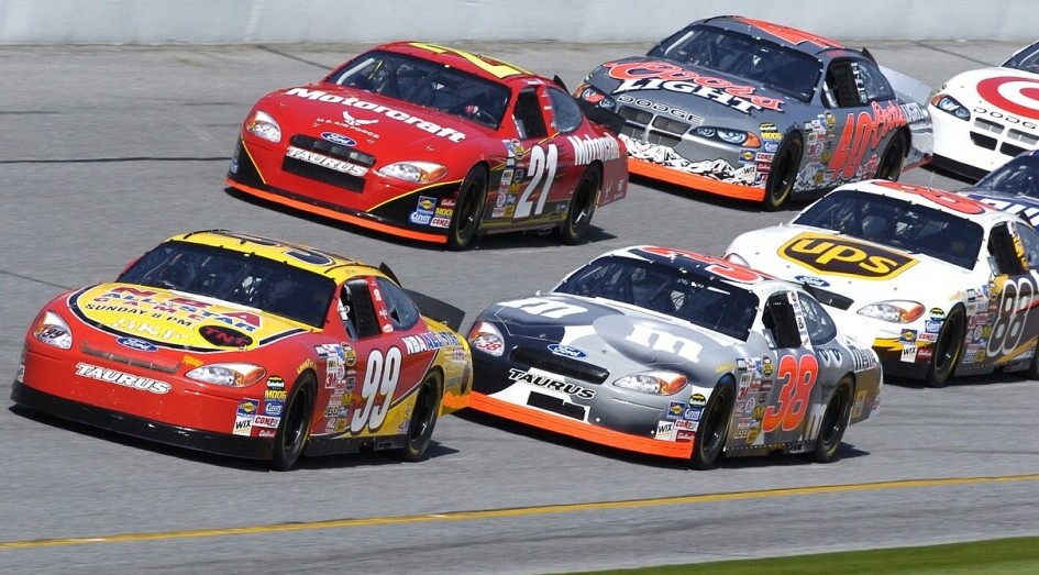 seven NASCAR Racing Cars at speed