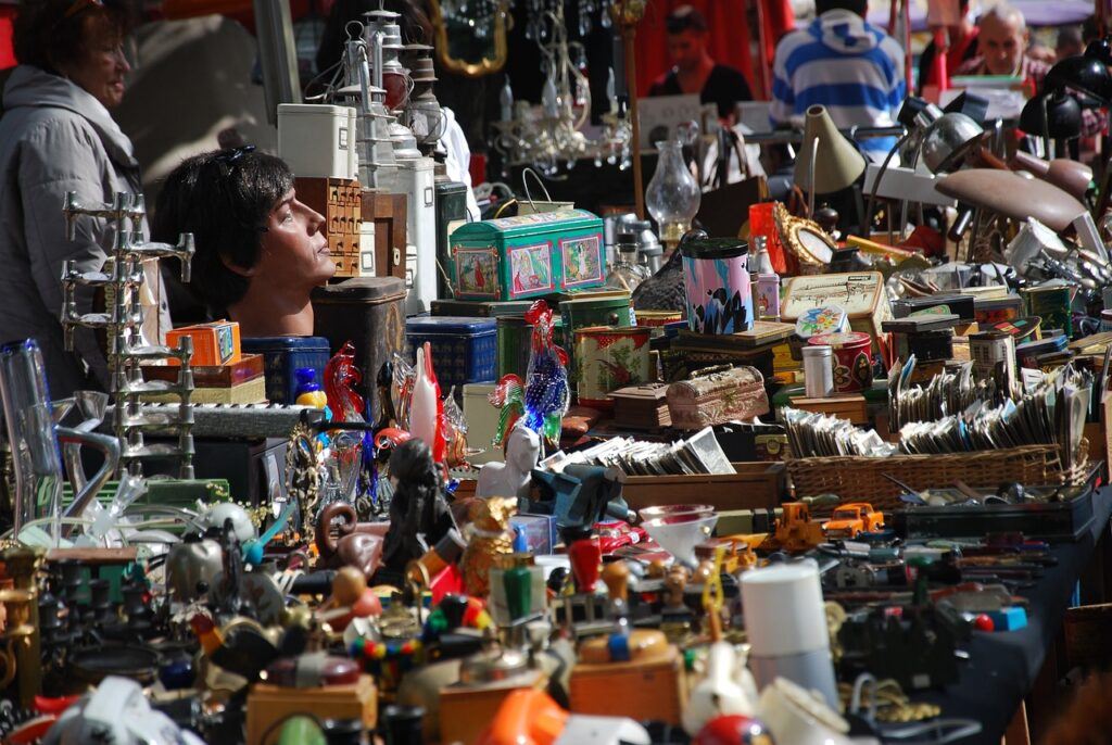 How to Start a Blog for Income; - A flea market image, showing all types of products for sale on a vendors table