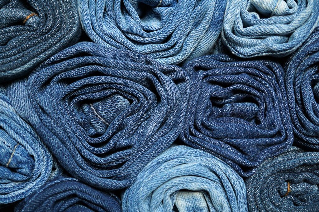 How to Pack Clothes So They Don't Wrinkle - A Pile of Rolled Denim Jeans