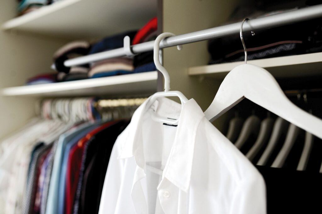 How to Pack Clothes So They Don't Wrinkle - A white shirt hanging up