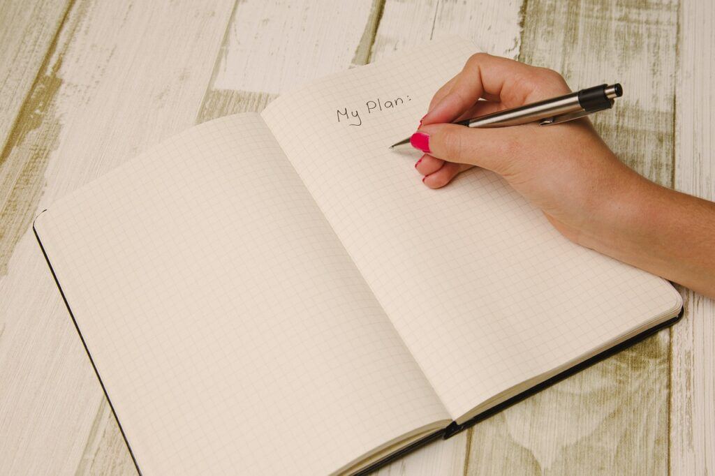 How to Build Wealth After 50 - Its Never Too Late to Secure Your Financial Future - Writing My Plan in a Blank Notebook Journal