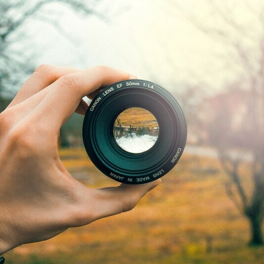 What is a Target Audience in Affiliate Marketing - a Hand holding up a camera lens to focus through