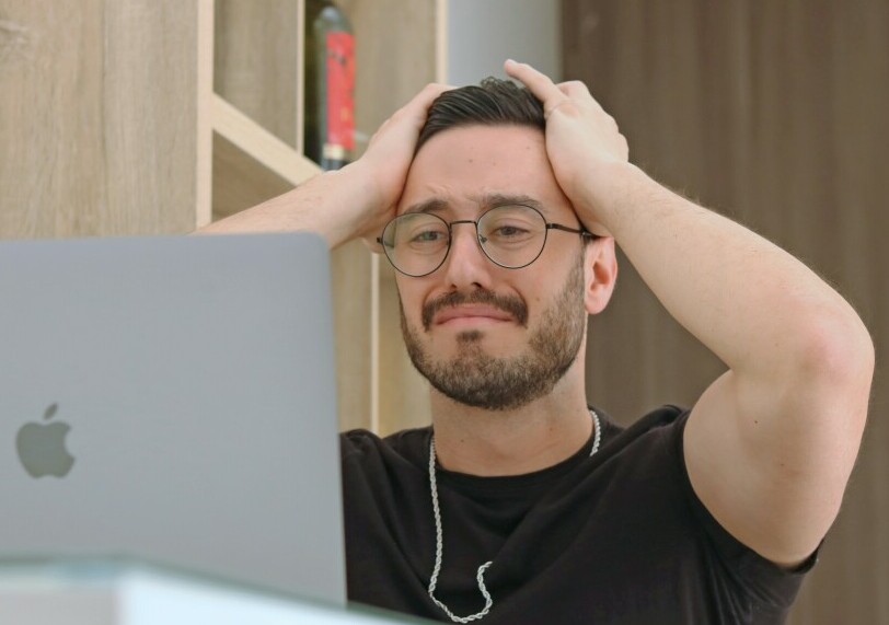 Why Do People Fail With Affiliate Marketing - A Man Looking at a Laptop screen, throwing his hands up in despair